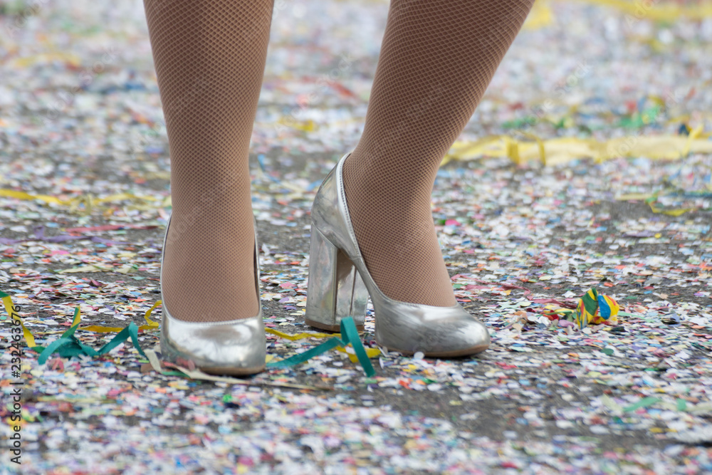 Closeup of silver shoes and confetti at Carnival