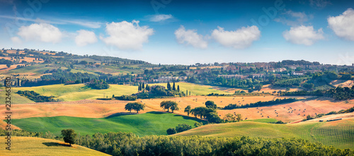 Wheat harvest in Tuscany. Typical Tuscan view of San Quirico d'Orcia. Colorful summer view of Italian countryside. Beauty of countryside concept background. © Andrew Mayovskyy
