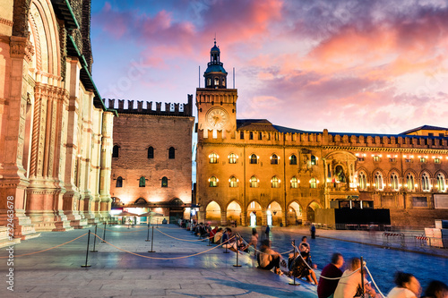 Photography Colorful spring sunset on the main square of City of Bologna with Palazzo d'Accursio and facade of Basilica di San Petronio