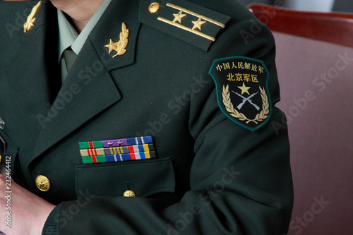 "Chinese people's liberation army (PLA), Beijing military area command " written on book of uniform armbands