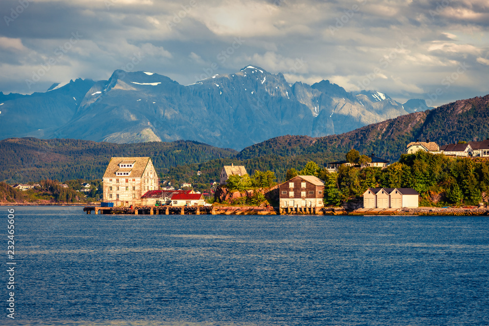 Suburbs of Alesund port town on the west coast of Norway, at the entrance to the Geirangerfjord. Colorful morning seascape of Norwegian Sea. Traveling concept background.