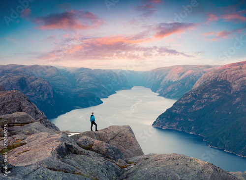 Colorful summer sunset on Lysefjorden fjord, located in the Ryfylke area in southwestern Norway. Active tourism concept background. Artistic style post processed photo.