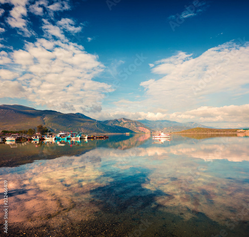 Sunny spring scene in the small fishing town - Mikrovivos. Splendid morning seascape of Aegean sea. Beauty of countryside concept background, Greece, Europe. Artistic style post processed photo.