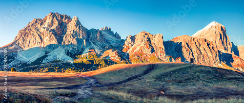 Panorama from top of Falzarego pass with Lagazuoi mountain. Colorful autumn morning in Dolomite Alps, Cortina d'Ampezzo lacattion, Italy, Europe. Beauty of nature concept background.

