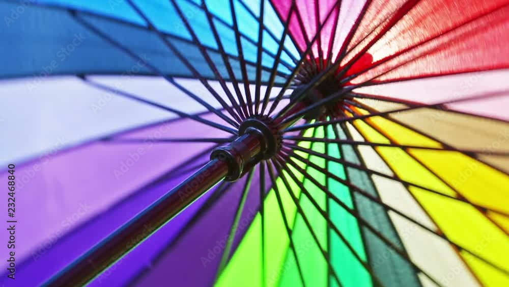 multicolored umbrella rotates. umbrella made of different color of fabric strips Stock Video