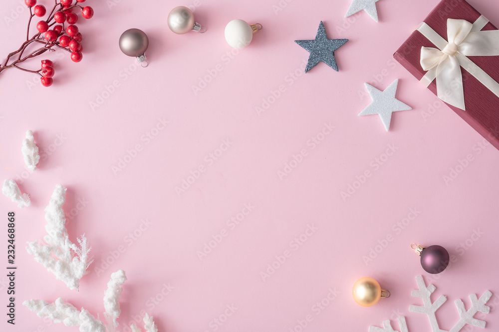 Winter Christmas table layout with New Year decoration on pastel pink background. Minimal nature concept. Flat lay top view composition.