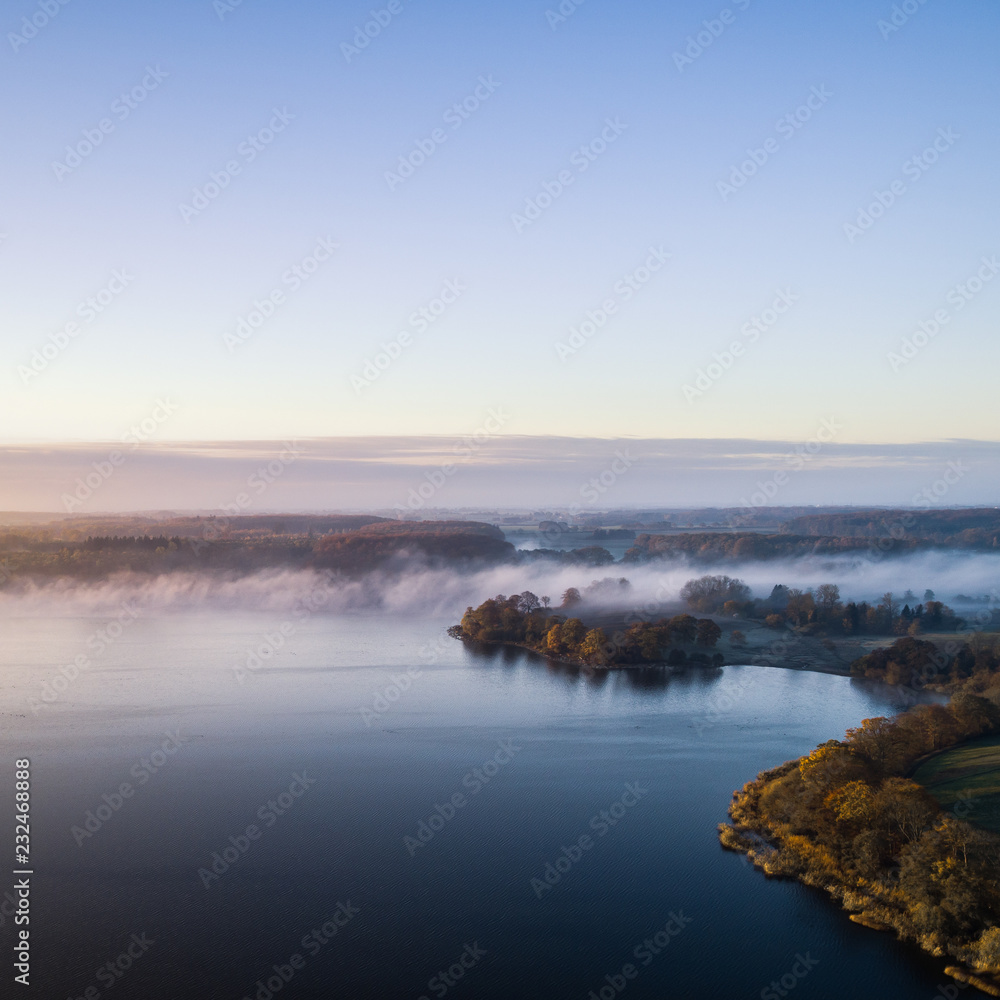 Morning mist on the banks of big lake