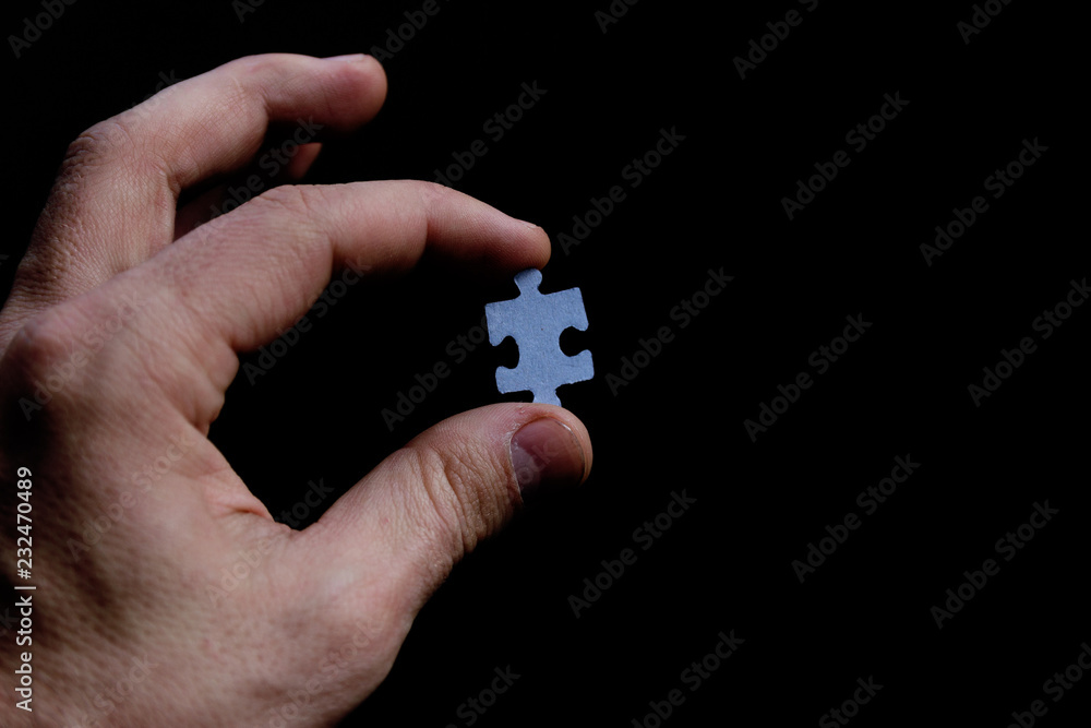 Plain white jigsaw puzzle on black background.