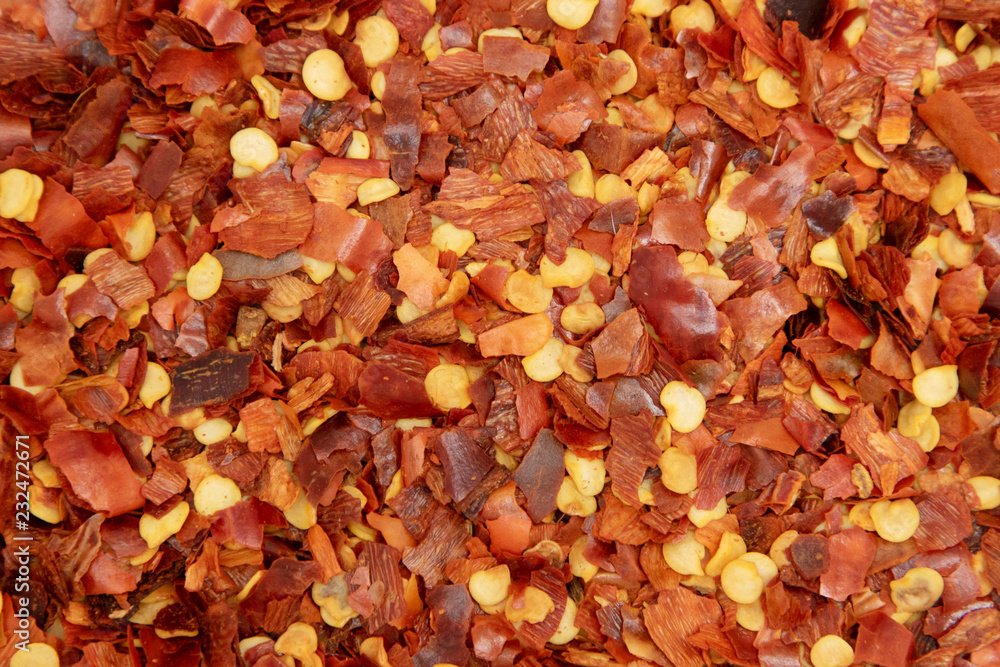 pile crushed red cayenne pepper, dried chili flakes and seeds pile crushed red cayenne pepper, dried chili flakes and seeds