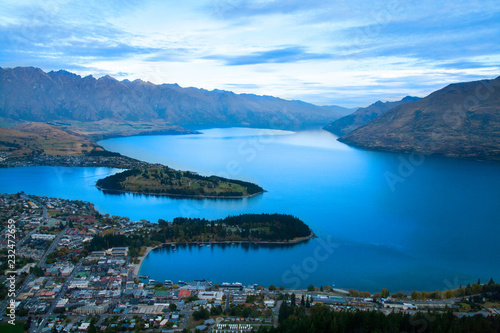 Scenic view of alpine resort town Queenstown New Zealand with famous landmarks The Remarkables mountains and Cecil peak, tourist holiday destination in Southern Alps, Otago