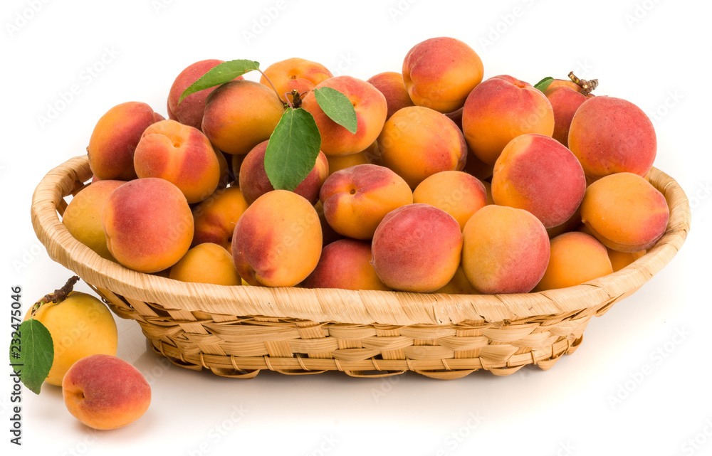 Apricots in a basket isolated on white Apricots in a basket isolated on white