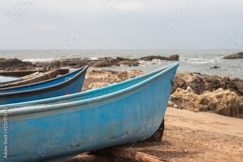 Fishing boat docked on a rocky shore in Vagator Goa