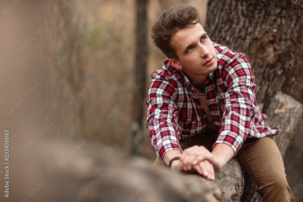 Handsome young guy in nature on an autumn day Handsome young guy in nature on an autumn day
