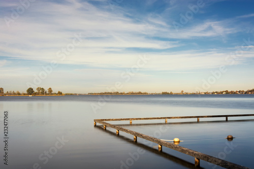 View on the Loosdrechtse plassen, the Netherlands. An area with several connected beautiful lakes,  Ideal for boating, swimming, aquatics, relaxing and enjoying a waterrich environment © Jet