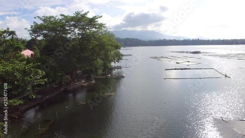 Sampaloc Lake, San Pablo City, Laguna, Philippines - November 21, 2017:  Trees and vegetation on mountain lake shore. Drone aerial. photo