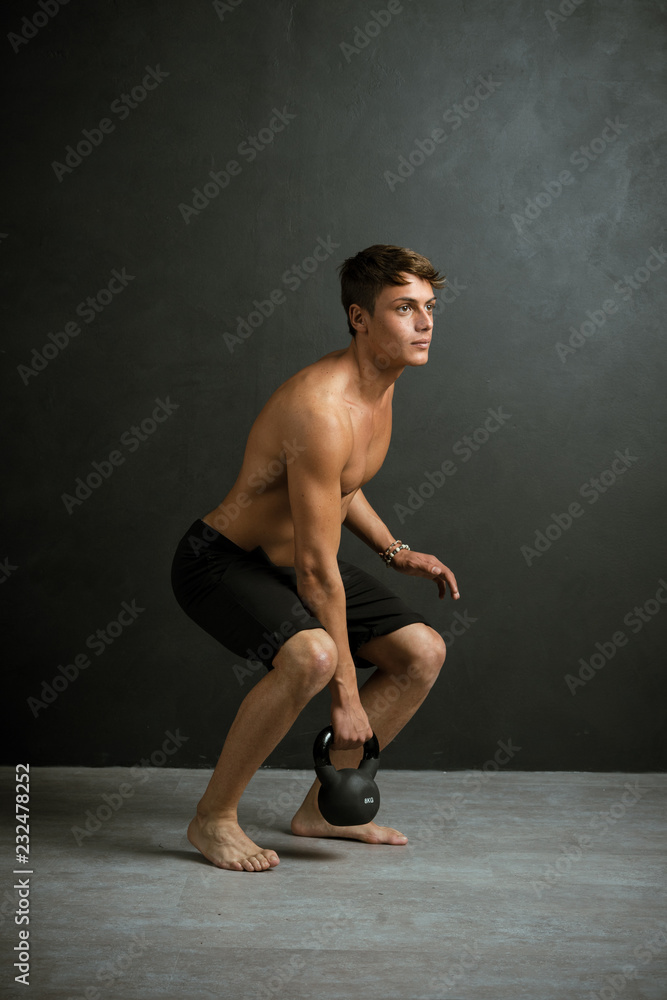 Young boy performing physical exercises on black background Young boy performing physical exercises on black background