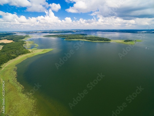 Aerial view of beautiful landscape of lake district - Mamry Lake, Upalty - the biggest island of Mazury region in the distance, Poland