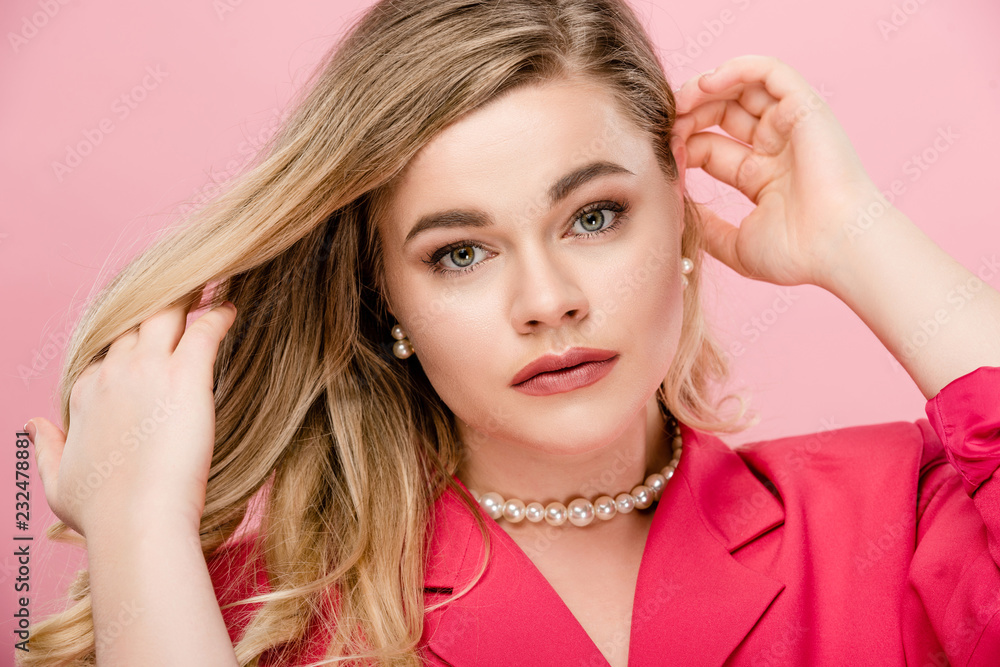 portrait of beautiful elegant plus size woman looking at camera isolated on pink