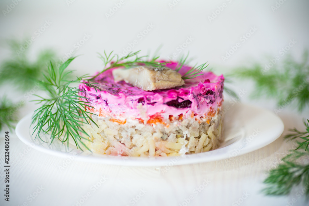layered salad of boiled vegetables with beets and herring