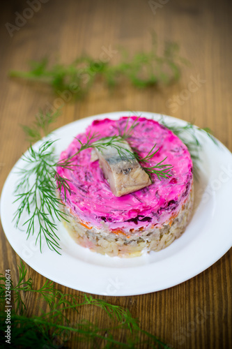 layered salad of boiled vegetables with beets and herring