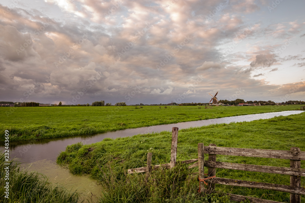 Beautiful clouds in pastel colors over the countryside in the western part of Holland