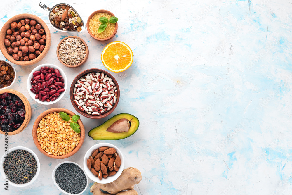 Healthy food. Superfoods Nuts, berries, fruits, and legumes. On a white stone background. Top view. Free copy space. Healthy food. Superfoods Nuts, berries, fruits, and legumes. On a white stone background. Top view. Free copy space.