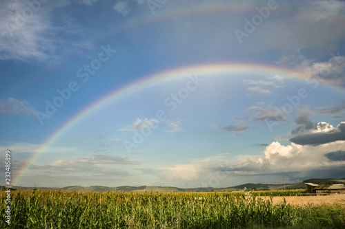 Bright double rainbow over the romanian countryside