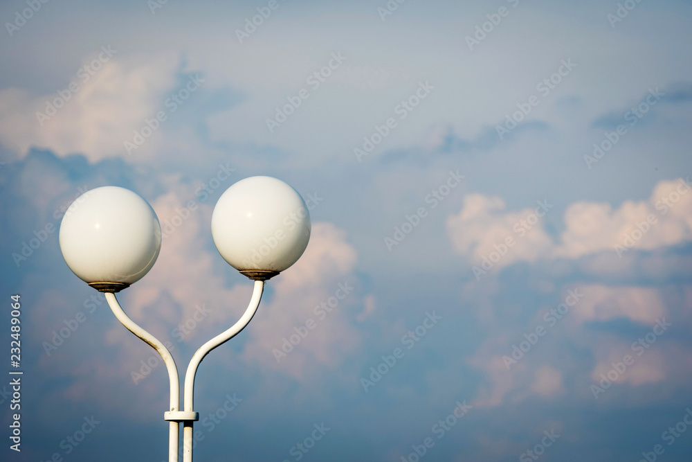 Lantern with two round domes on the blue sky background. Lantern with two round domes on the blue sky background.