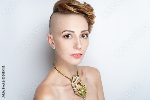 Fototapeta girl with a short haircut and a shaven temple