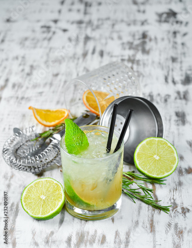 Caipirini with Rom. Alcoholic cocktail in a glass. On a wooden background. Top view. Free copy space.