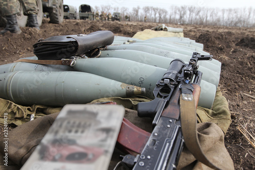 AK-47 near the artillery shells
