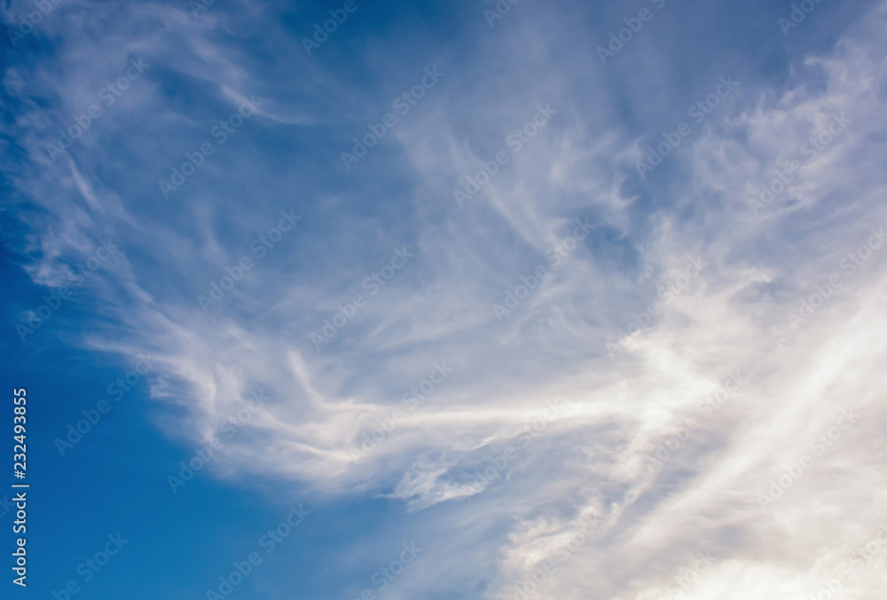 White soft fluffy clouds scatter over blue sky background. Beautiful soft white clouds in clear blue sky, the end of rainy season. White soft fluffy clouds scatter over blue sky background. Beautiful soft white clouds in clear blue sky, the end of rainy season.