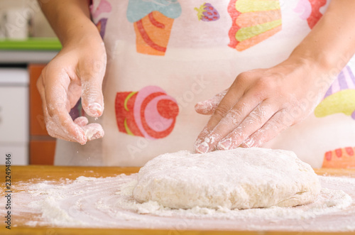 Woman's hands kneading the dough