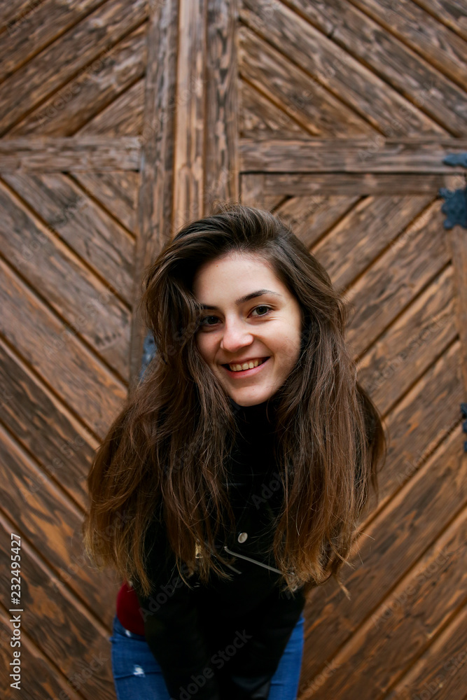 Fototapeta premium Beautiful girl in a leather jacket in the old place