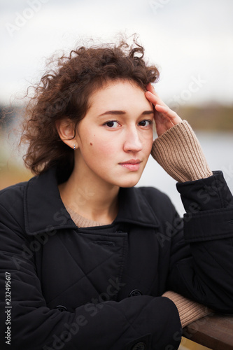 sad girl in autumn in a park photo