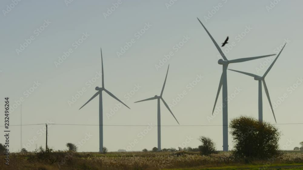 Wind turbines turning on a wind farm, in slow motion Wind turbines turning on a wind farm, in slow motion