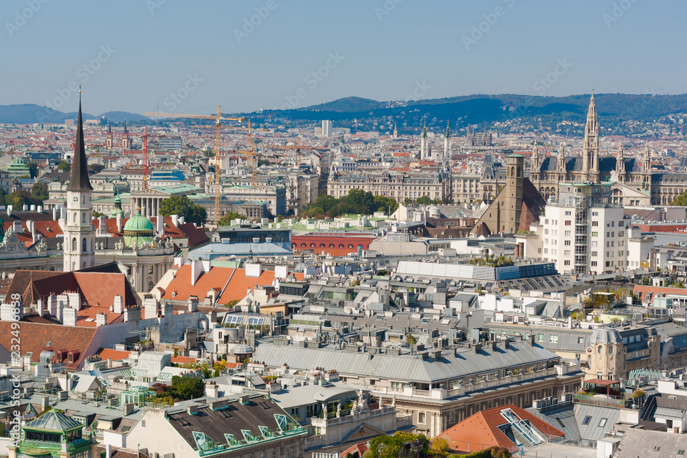 Vienna, Austria, September 09,2018:  Aerial view of Vienna with tower of the town hall building, votivkirche and peterskirche churches from the stephansdom cathedral.