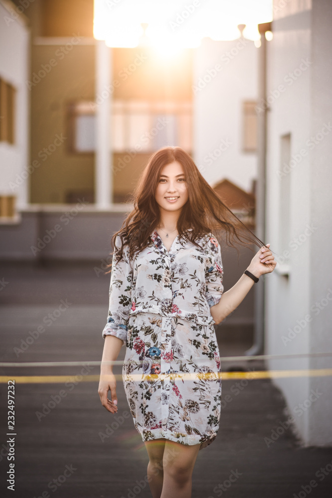 beautiful smiling brunette holding her hair in the hands