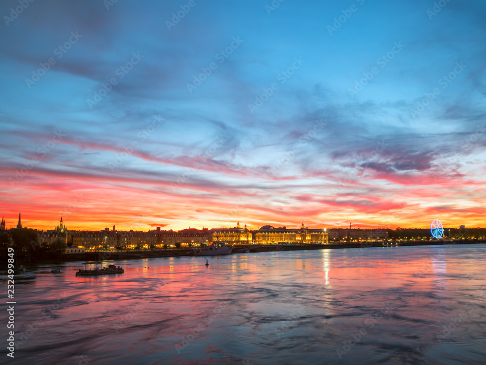 Beautiful view of Bordeaux city and the garonne river with amazing dramatic sunset sky, France.