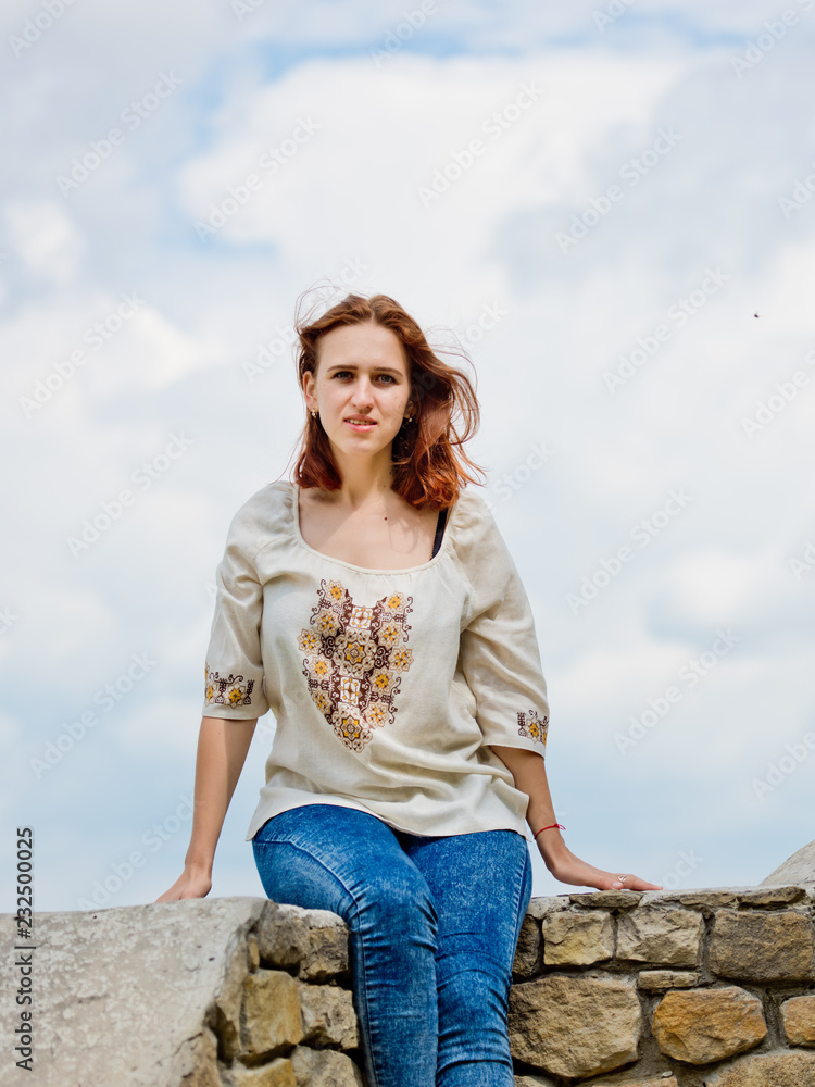 Beautiful young girl with red hair posing against nature background. Beautiful young girl with red hair posing against nature background.