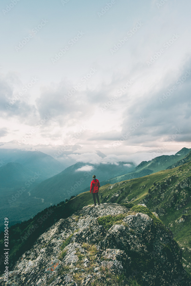 Man hiking alone in mountains adventure  solo traveling solitude lifestyle concept active vacations moody nature