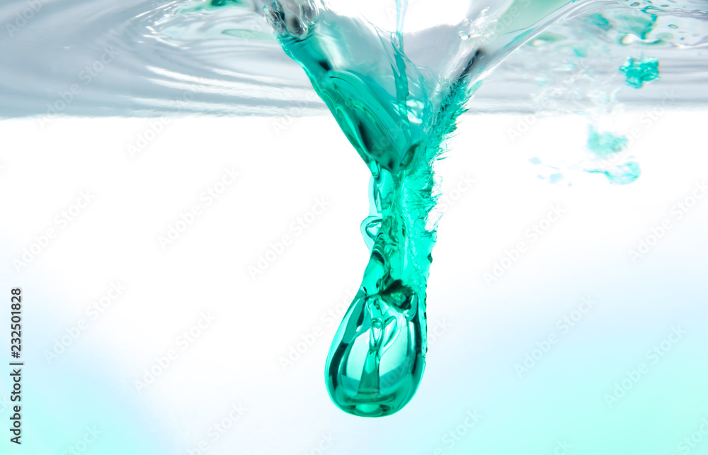 Underwater splash from falling dark green syrup
