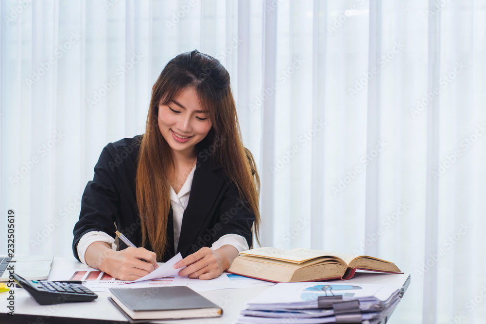 Photo of business woman working with document graph for startup new project at office. Photo of business woman working with document graph for startup new project at office.