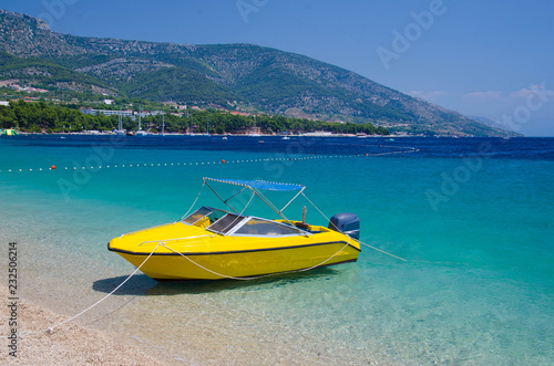Yellow boat near cape Zlatni Rat of Brac Island, Adriatic Sea, Croatia