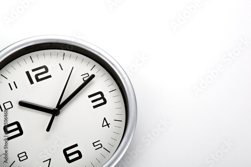 white clock face with black digits on a white background closeup