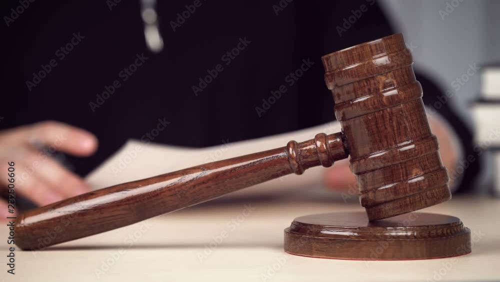 Judge reading papers, checking evidence, working at desk in courtroom. Justice. Judge working in courtroom Judge reading papers, checking evidence, working at desk in courtroom. Justice. Judge working in courtroom