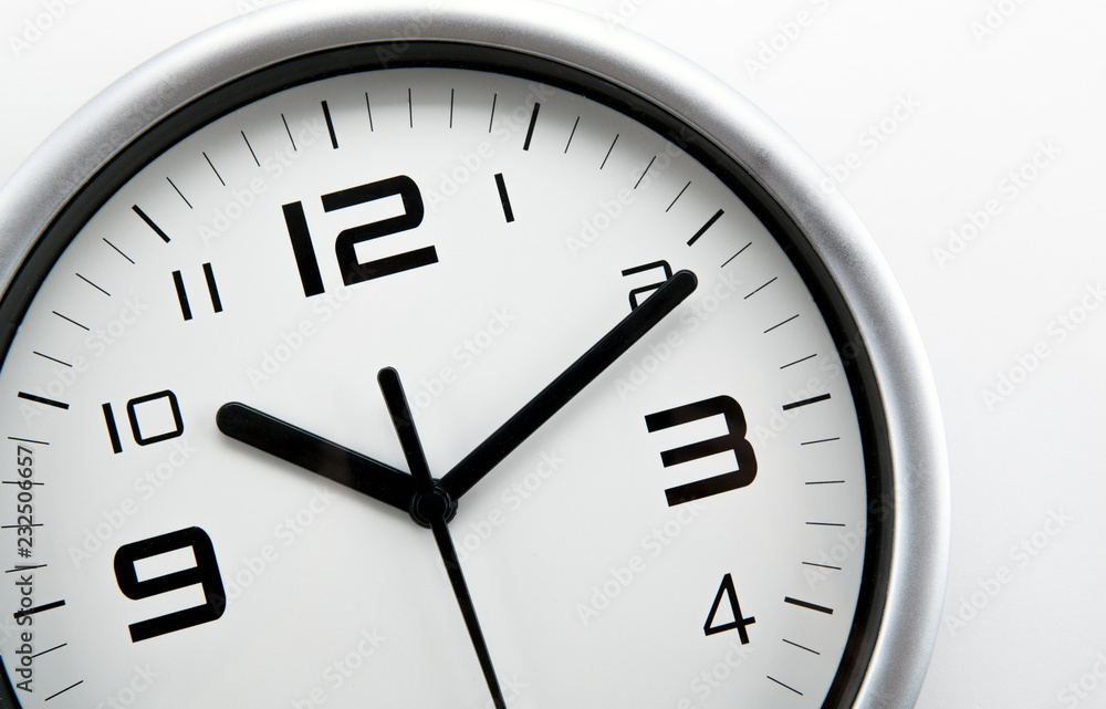 white clock face with black digits on a white background closeup