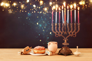 image of jewish holiday Hanukkah background with menorah (traditional candelabra) and burning candles.