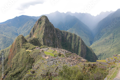 Machu Picchu with rain in valley behind