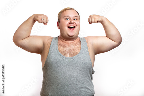 Obraz na plátně Happy plump softie fatso man posing in bodybuilder s stance, enjoying sport and healthy lifestyle